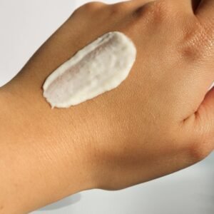 Close-up of a hand with cream applied, ideal for skincare and moisturizer concepts.